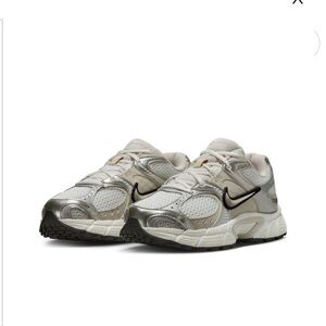 Nike women’s Metallic Silver and White Sneakers bundle free, bottled water